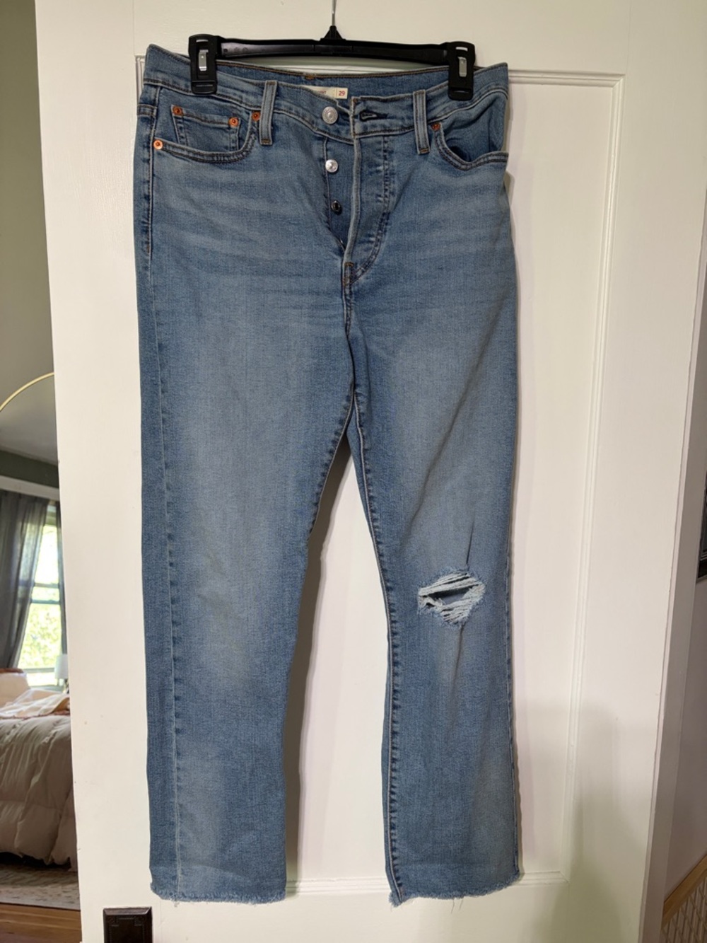 Levi's Light Blue Straight-Leg, button front, raw hem Jeans with Knee Rip